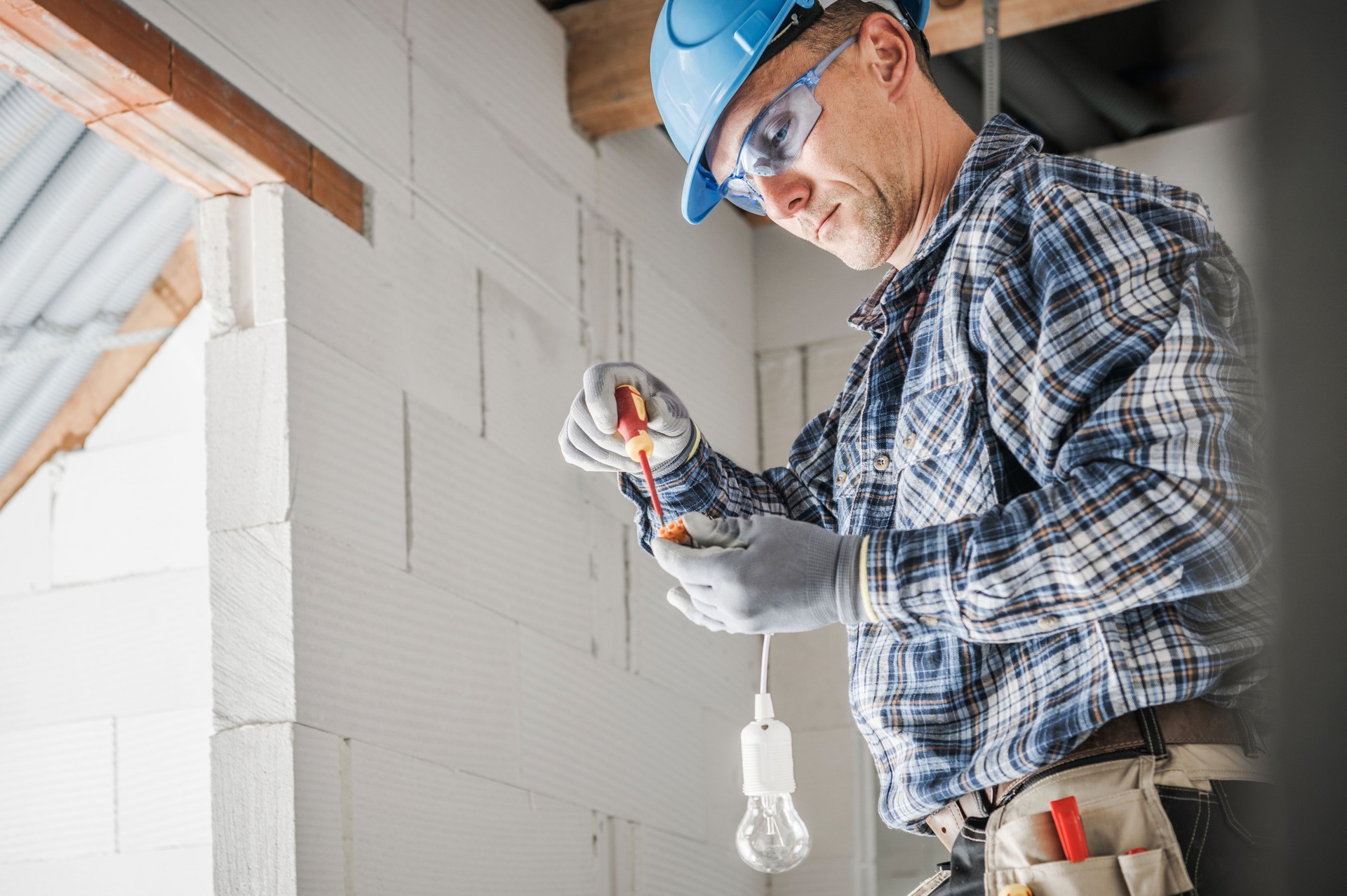 Electrician Preparing a Light Point Inside Newly Built House Electrician Preparing a Light Point Inside Newly Built House